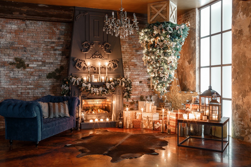 alternative tree upside down on the ceiling. Winter home decor. Modern loft interior with fireplace and brick wall