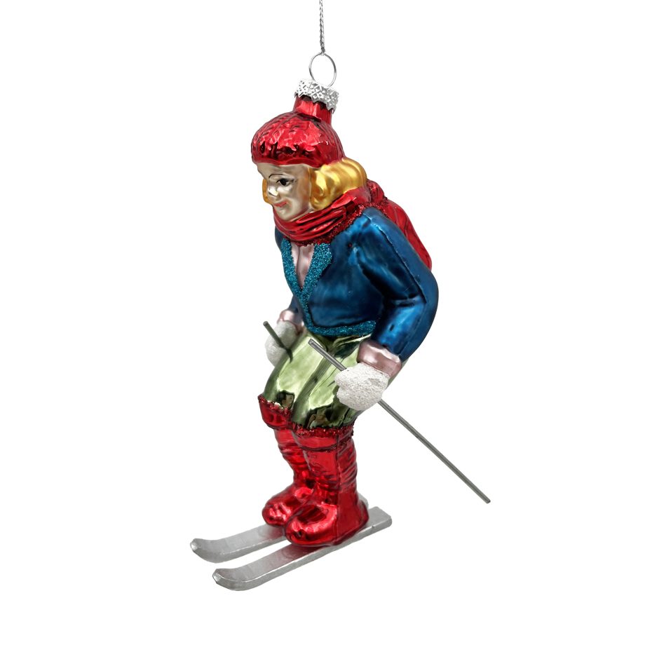 ORN GLASS SKIING GIRL 6" RED HAT, TEAL JACKET, YELLOW SCARF, RED SKI BOOTS BLUE/MULTI GLITTER