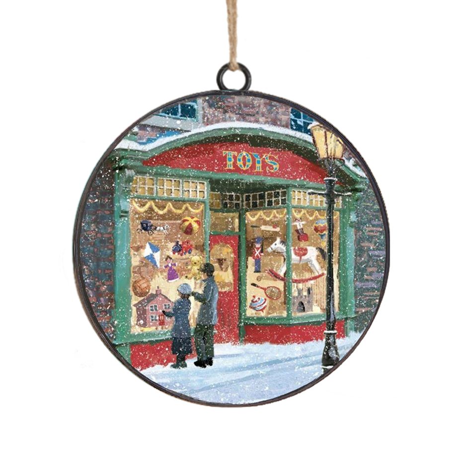 ORN METAL DISC 4" TOY SHOP SCENE ON A SNOWY DAY